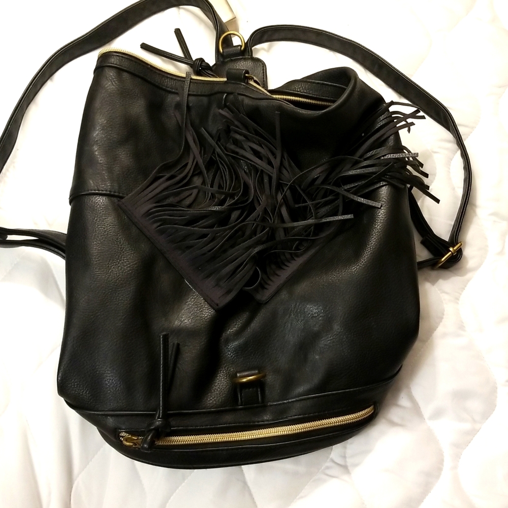 Black leather backpack no name leather straps tastles on the front
